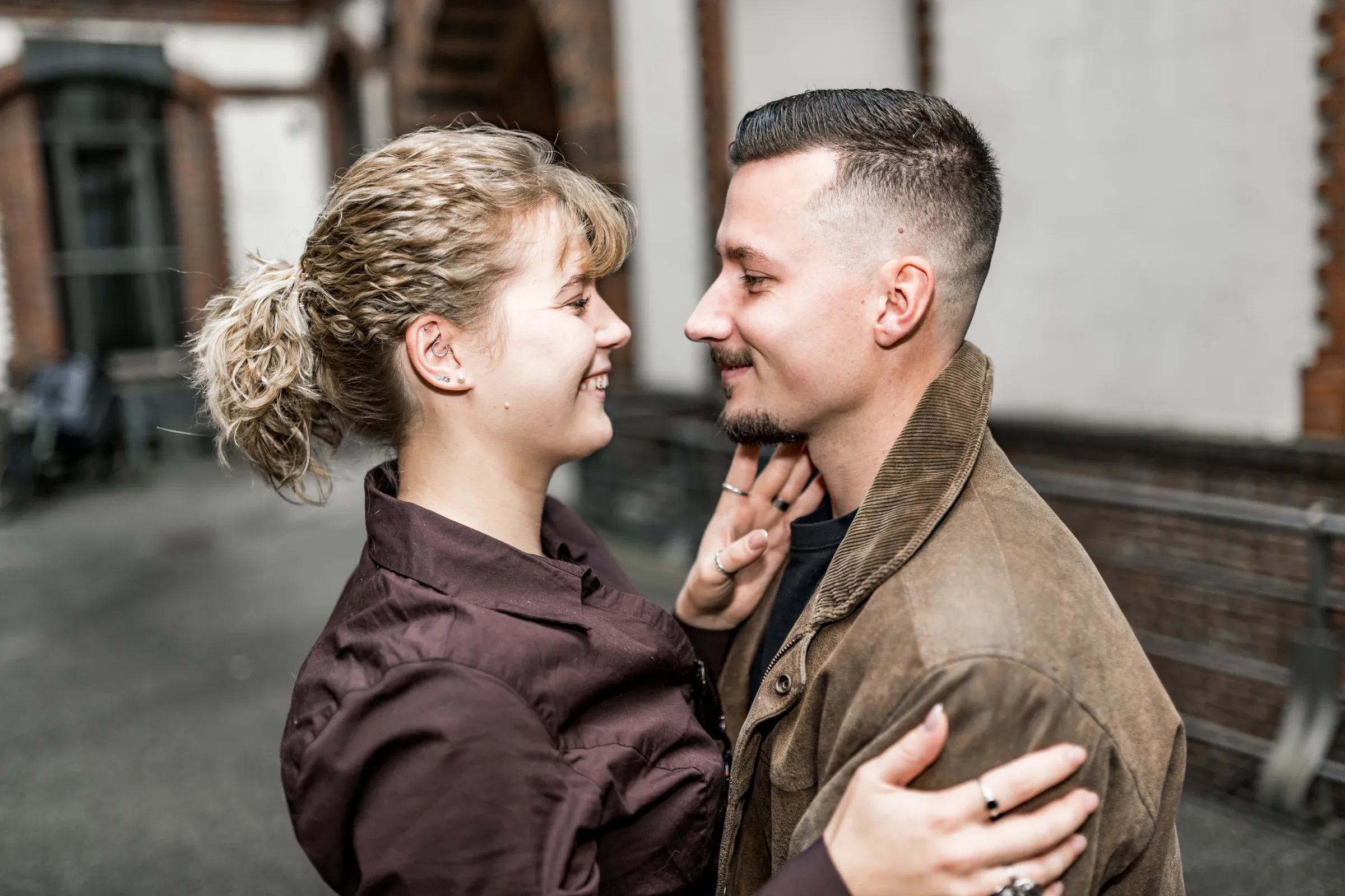 Liza und Domenic lächeln einander in einer schmalen Speicherstadtgasse an